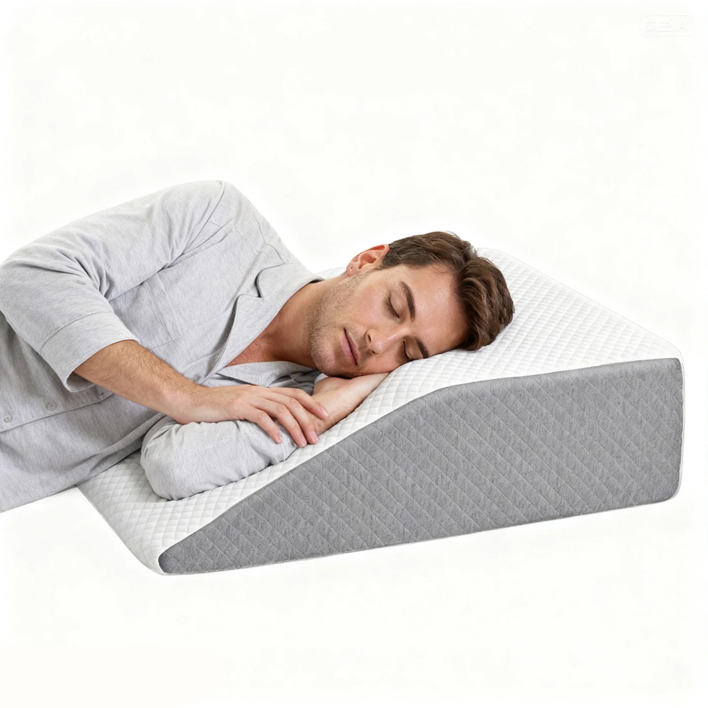 Original photograph of an adult resting on the white and gray inclined wedge pillow